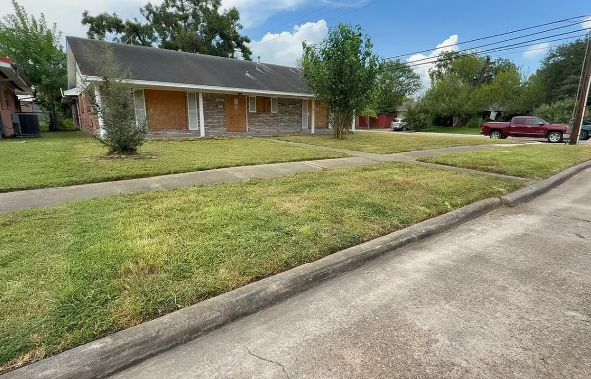 aiken lawn service after — clean green mowed lawn on corner lot with crisp edging