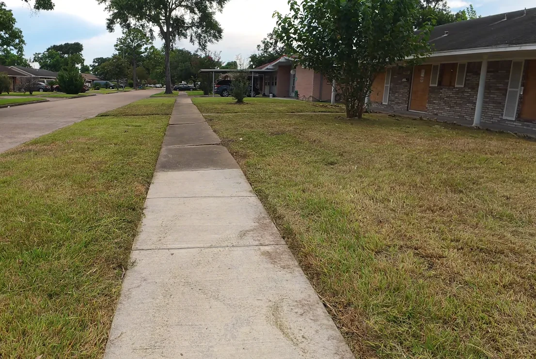 lawn services aiken after — manicured front yard with clean beds and even mowing stripes