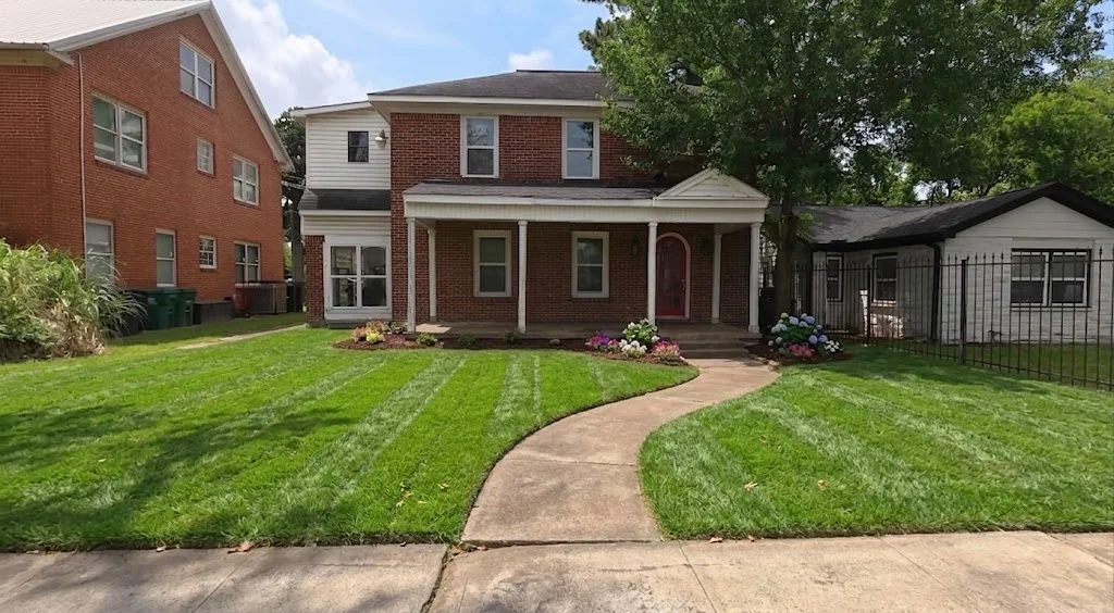 lawn care aiken sc — professional lawn mowing service with pristine striped lawn and brick home