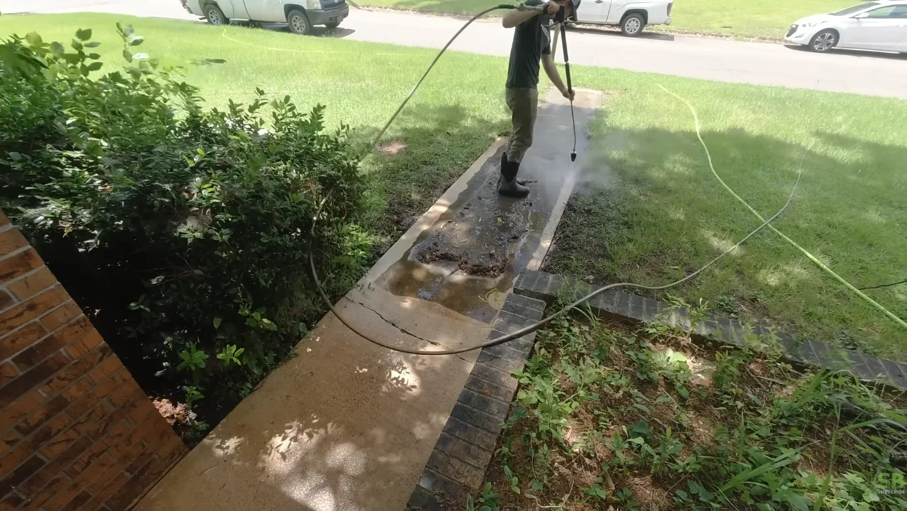 lawn care aiken sc professional team performing edging and mowing services on residential property